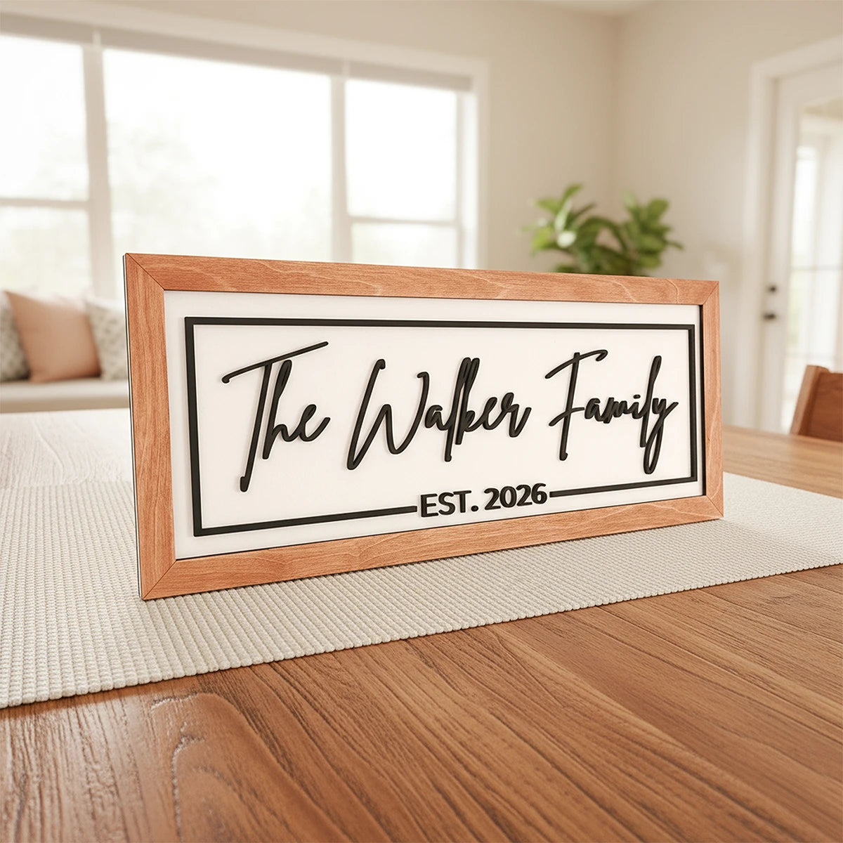 Framed sign with 'The Walker Family EST. 2026' on a wooden table.